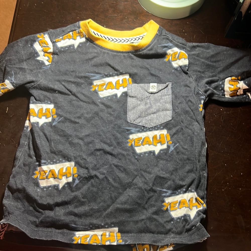 Sovereign Code 4t comic shirt with yellow pop of color and jean pocket.